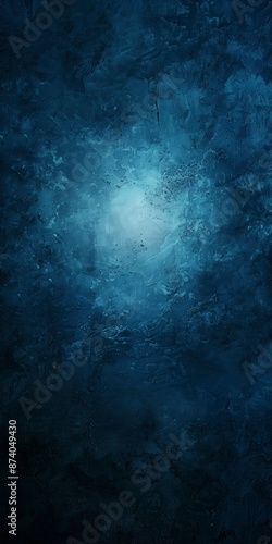 Abstract blue background with bright center spotlight and dark vignette border frame with vintage grunge background texture.