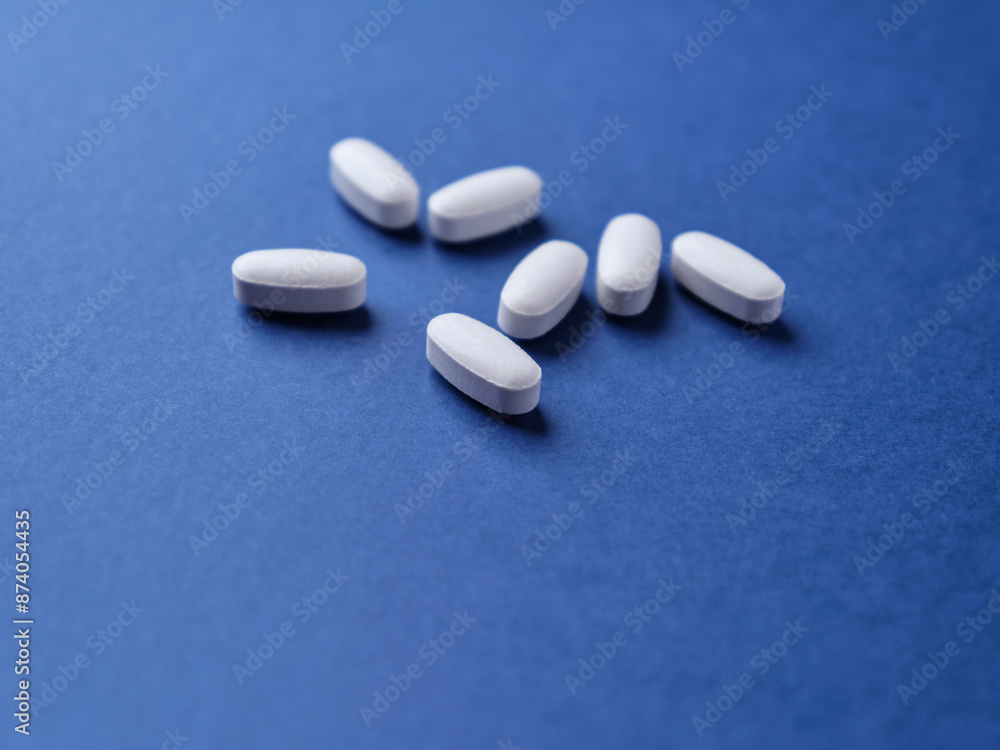 Amino acids tablets. Nutrition for bodybuilding. Fitness supplements on dark paper background. Soft focus. Copy space. Amino acids tablets. Nutrition for bodybuilding. Fitness supplements on dark paper background. Soft focus. Copy space.