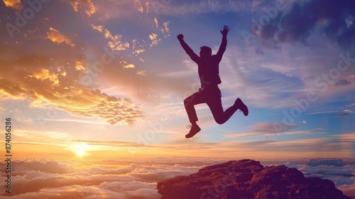 Silhouette of a Man Jumping Over Clouds at Sunset © Bolustck