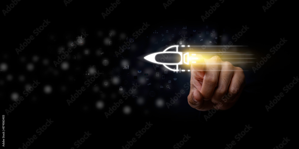 Startup business concept, Businessman touch rocket virtual icon and fast start up business. Strategic planning and business success. Wealth fast, rising earning, increasing profits financial success.