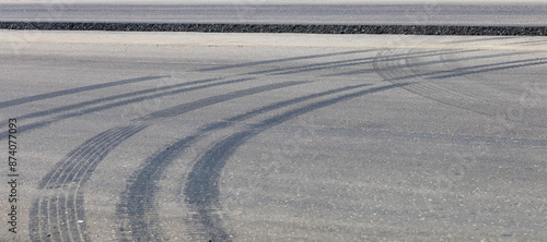 A road with tire tracks on the asphalt