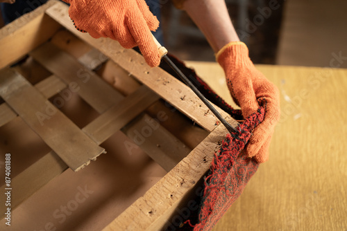 Fotografía Seasoned Female Restorer Taking Off Worn Fabric from Antique Arm Chair Seat