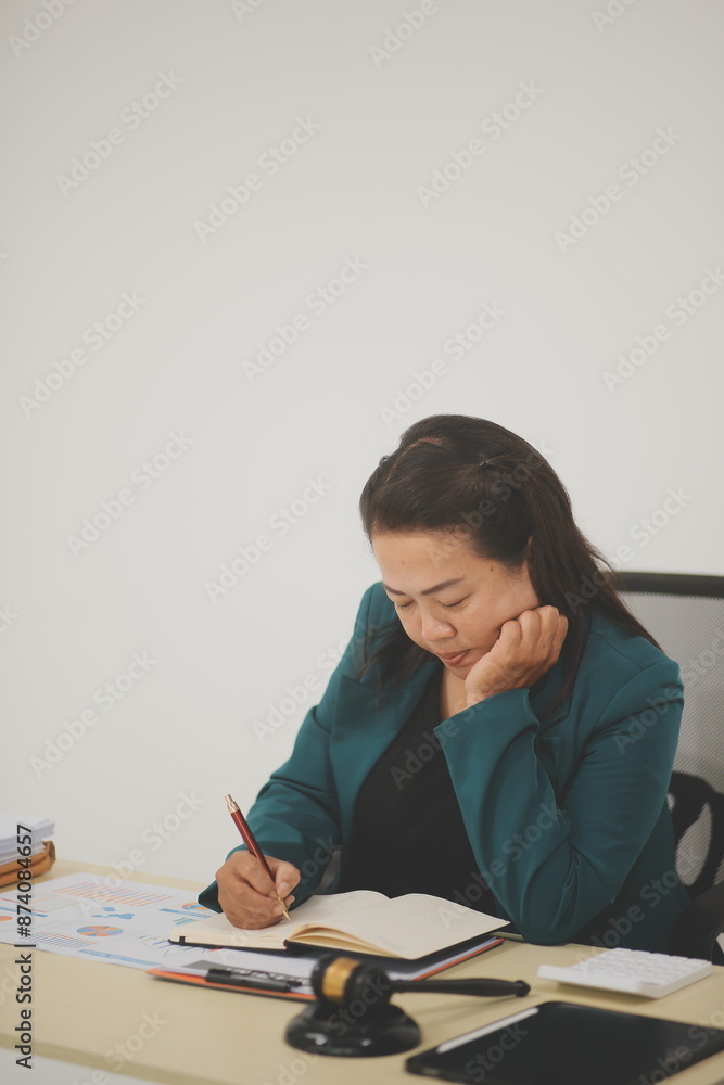 Pretty Asian female lawyer working and hammer, laptop, justice advice and legal concept. In office Pretty Asian female lawyer working and hammer, laptop, justice advice and legal concept. In office