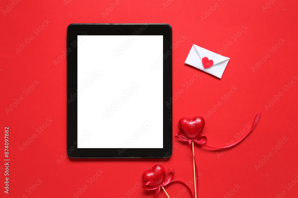 Tablet computer with love letter and hearts on red background. Concept of online dating Tablet computer with love letter and hearts on red background. Concept of online dating