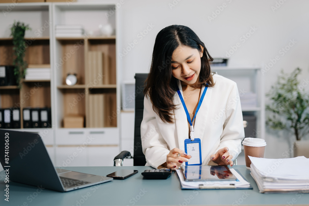 Asian Businesswoman Analyzing Finance on Tablet and Laptop at modern Office Desk Asian Businesswoman Analyzing Finance on Tablet and Laptop at modern Office Desk
