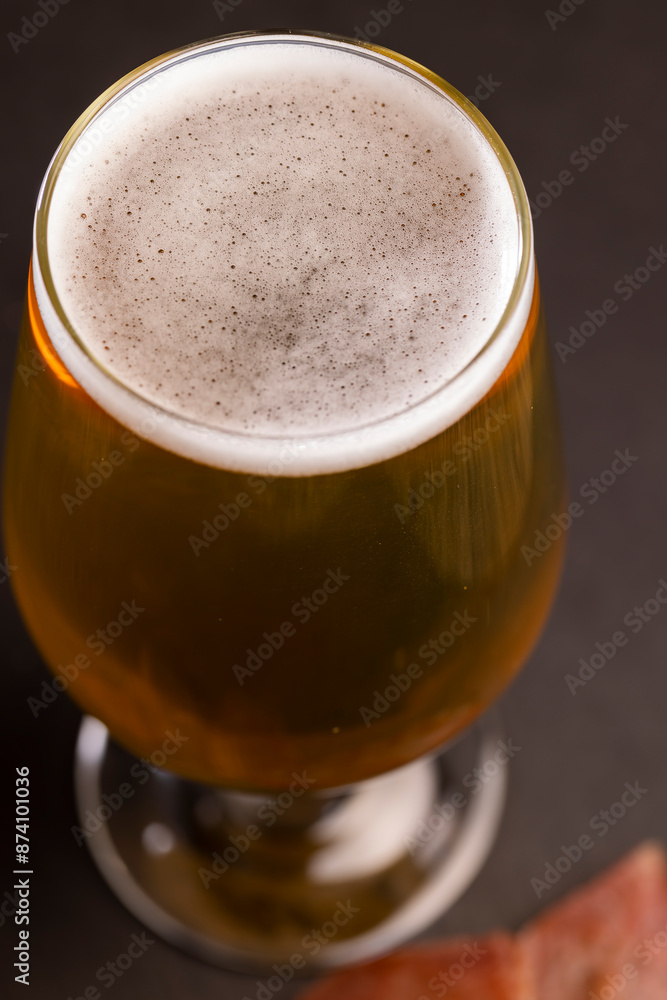 light golden beer in a glass glass on a black background light golden beer in a glass glass on a black background