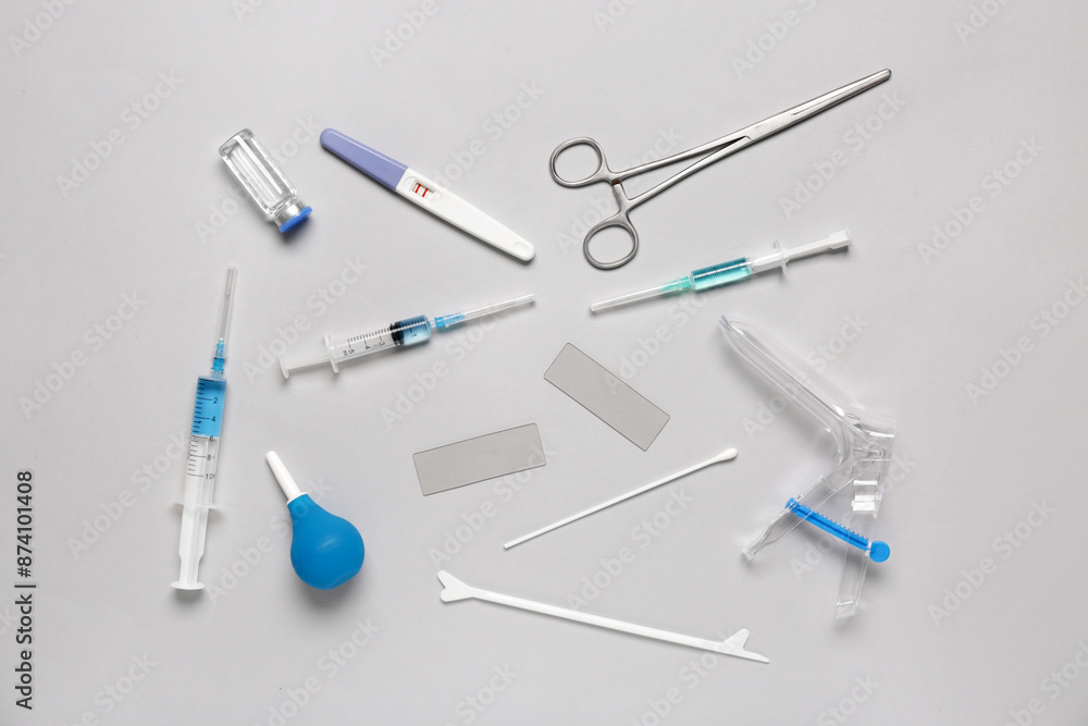 Gynecological speculum with pap smear test tools, syringes and ampule on white background Gynecological speculum with pap smear test tools, syringes and ampule on white background