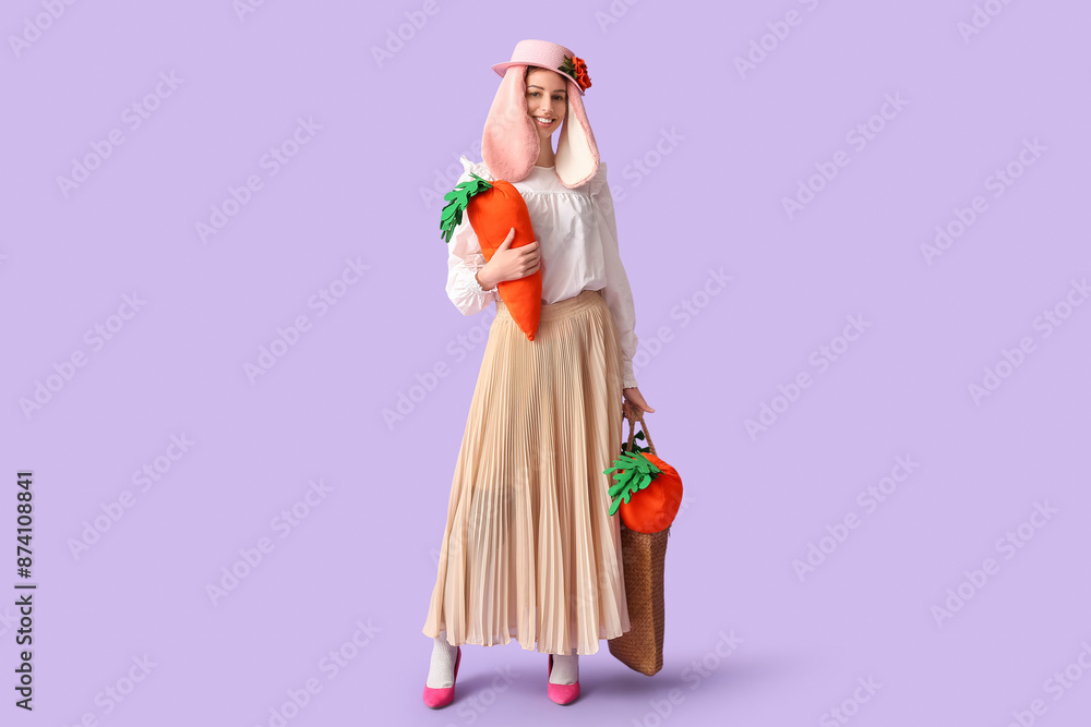 Stylish woman with bunny ears holding carrot toys on lilac background. Easter celebration Stylish woman with bunny ears holding carrot toys on lilac background. Easter celebration