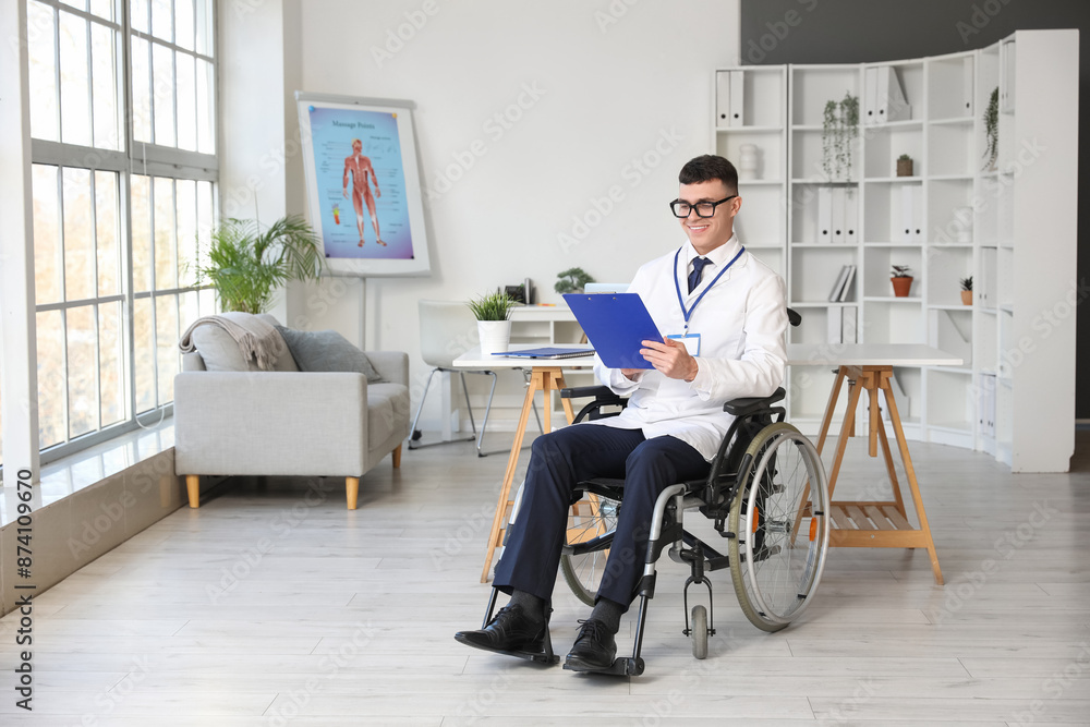 Young male doctor in wheelchair with clipboard at hospital Young male doctor in wheelchair with clipboard at hospital