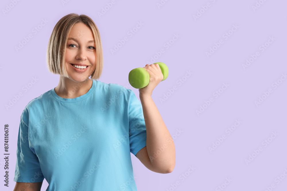 Pretty young woman exercising with dumbbell on lilac background. Weight loss concept Pretty young woman exercising with dumbbell on lilac background. Weight loss concept