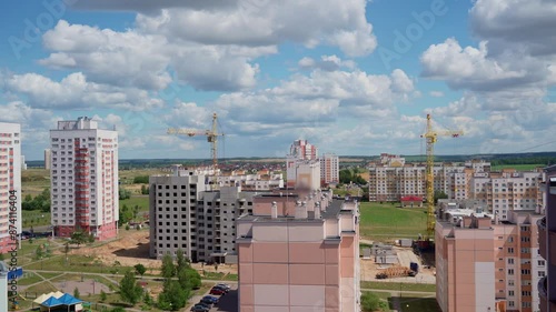 Construction Site in the city view. Two working cranes. Building a new place of living for people. Can be used as backgrounds. Real time