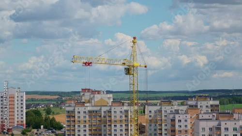 Moving Crane In The City. Field At The Background. Sunny Day. Construction Site