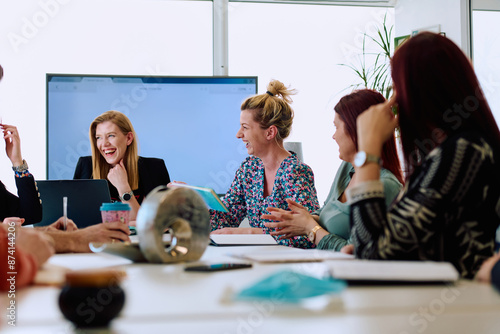 Diverse Business Team Discussing Projects in a Modern Glass Office. photo