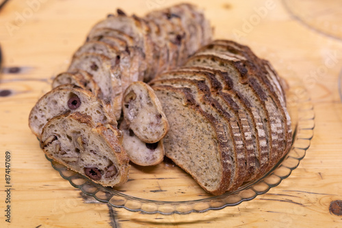 A platter of sliced bread with olives photo