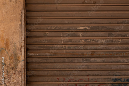 A worn metal shutter with g...