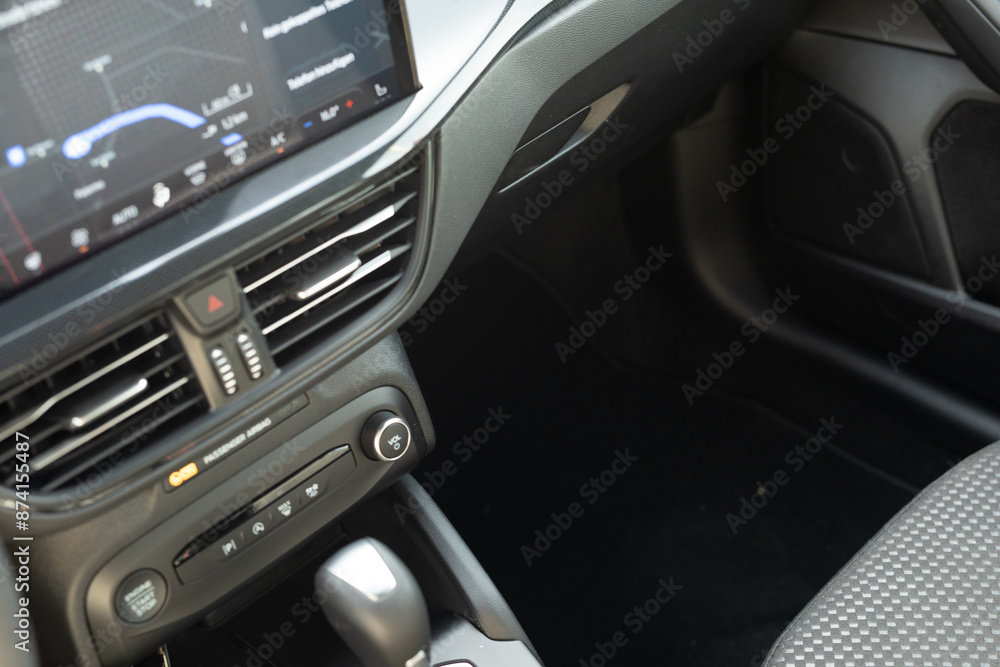 The interior of a modern car with a sleek and minimalist design The interior of a modern car with a sleek and minimalist design
