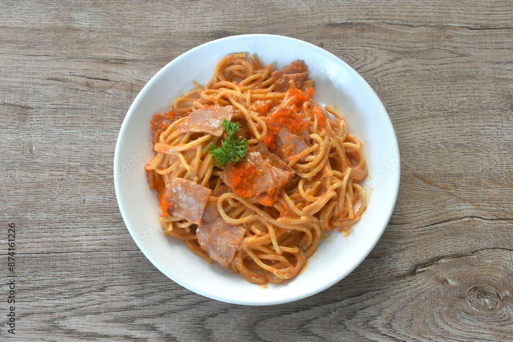 spicy stir fried spaghetti with slice ham pork dressing Rose Korean sauce topping shrimp egg on plate spicy stir fried spaghetti with slice ham pork dressing Rose Korean sauce topping shrimp egg on plate