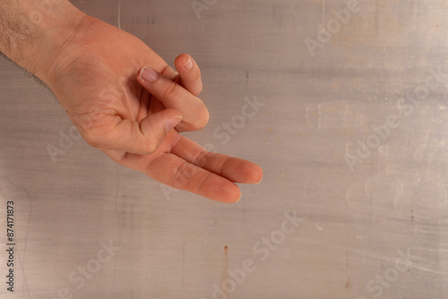 A hand makes the peace sign