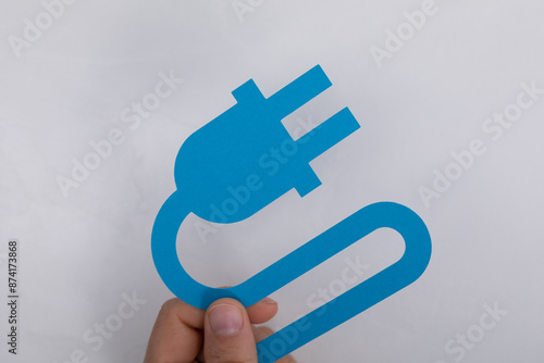 A hand holds a blue paper c...