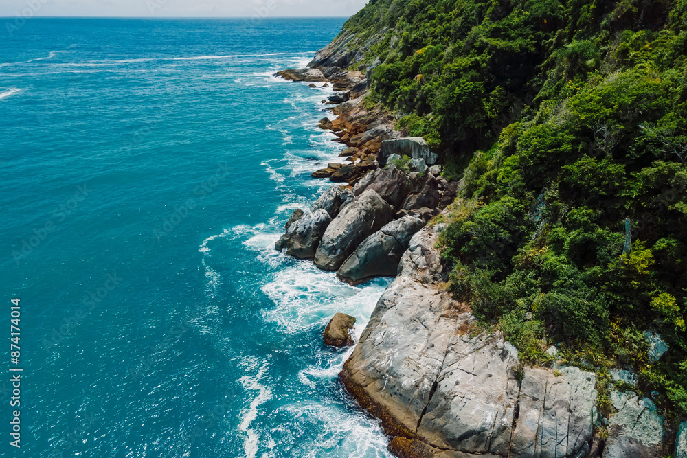 Fototapeta premium Coastline with rocks and blue ocean in Brazil on Matadeiro Beach. Aerial view