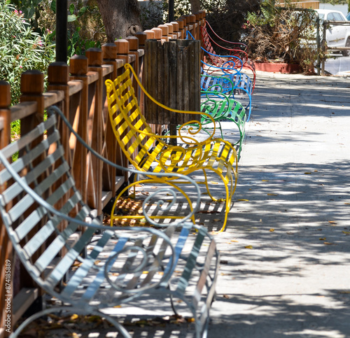 Bright and Colorful Benches Lining the Park in Bright, colorful benches lining the park, offering vibrant seating on a sunny summer daySummer, photo