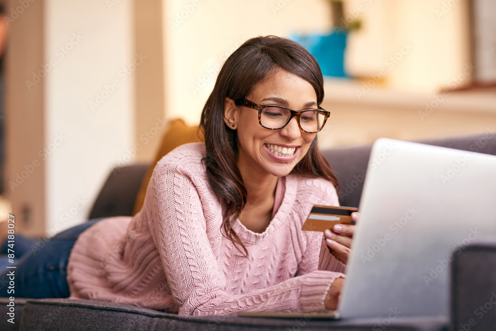 Debit card, laptop and woman relax in home with happiness for paying bills with debt free lifestyle. Smile, computer and person on sofa with internet banking app to apply for mortgage in apartment. Debit card, laptop and woman relax in home with happiness for paying bills with debt free lifestyle. Smile, computer and person on sofa with internet banking app to apply for mortgage in apartment.