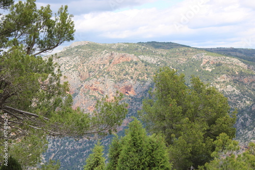 Mountains of El Maestrazgo, Castellón, Spain, rugged, rocky, colorful, and with trees photo