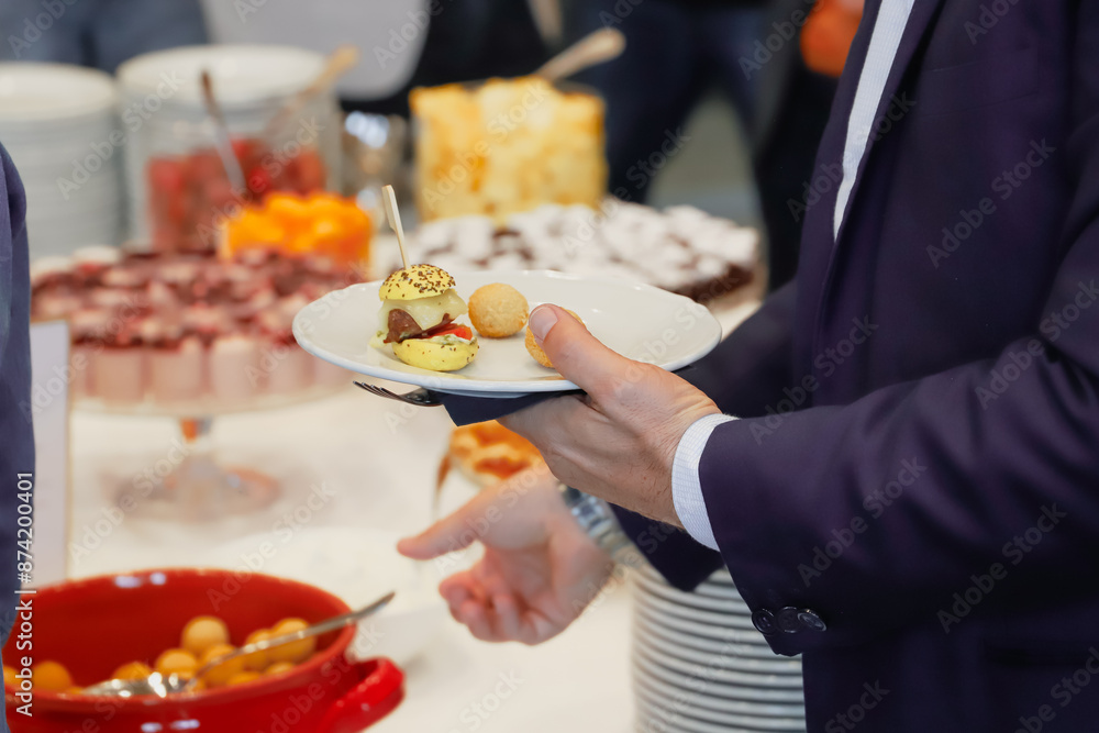 catering buffet food indoor in luxury restaurant with meat and vegetables - Close-up of the hands of a man and a woman holding a plate of food catering buffet food indoor in luxury restaurant with meat and vegetables - Close-up of the hands of a man and a woman holding a plate of food
