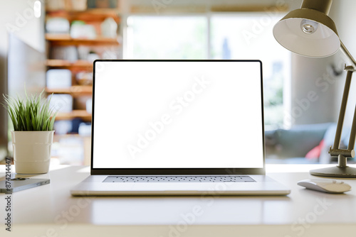 Laptop with a blank screen on a table in a bright home office. Perfect for inserting your own content. 3d render