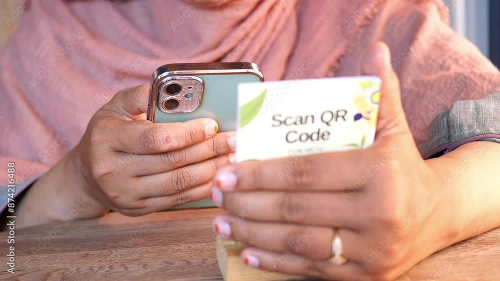 woman hand using the smart phone to scan the qr code to select food menu in the restaurant