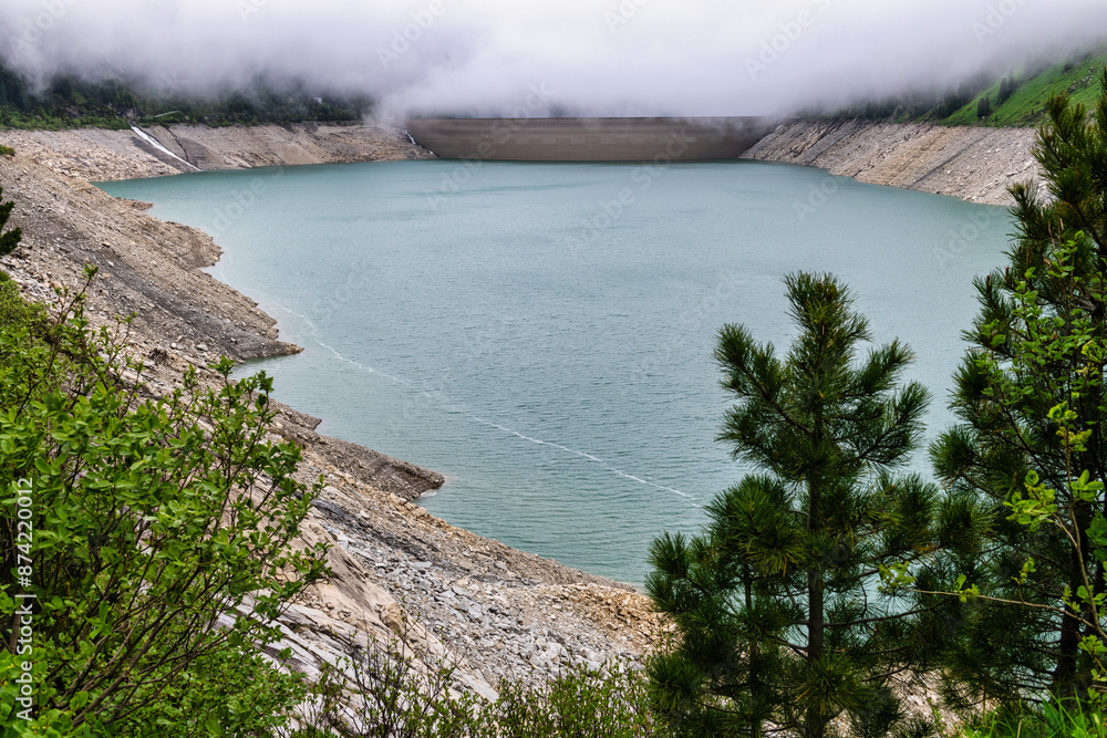 Schlegeis Reservoir located in the Zillertal Alps in Tyrol, Austria on a day with very low clouds. It is a crucial part of Austria’s hydroelectric infrastructure. Schlegeis Reservoir located in the Zillertal Alps in Tyrol, Austria on a day with very low clouds. It is a crucial part of Austria’s hydroelectric infrastructure.