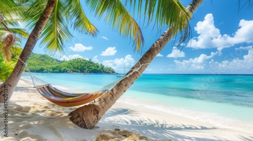 Tropical Haven: Hammock Sways Between Palm Trees on a White Sand Beach with Turquoise Waters