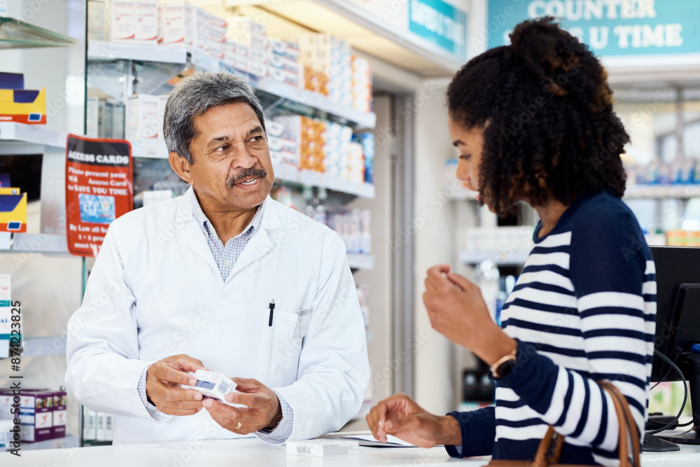 Obraz premium Mature, pharmacist and conversation with woman for help, prescription medication and wellness management. Female customer, man and speaking by counter for advice on medical treatment and healthcare.