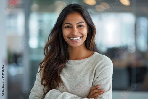 Portrait of a joyful indian woman in her 20s dressed in a comfy fleece pullover in front of sophisticated corporate office background Free Download Portrait of a joyful indian woman in her 20s dressed in a comfy fleece pullover in front of sophisticated corporate office background - GFXLoad