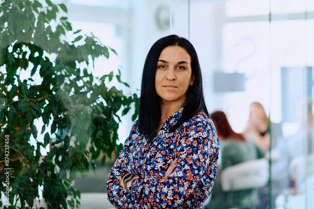 Portrait of a Confident Businesswoman with Crossed Arms in Her Office Environment. Portrait of a Confident Businesswoman with Crossed Arms in Her Office Environment.