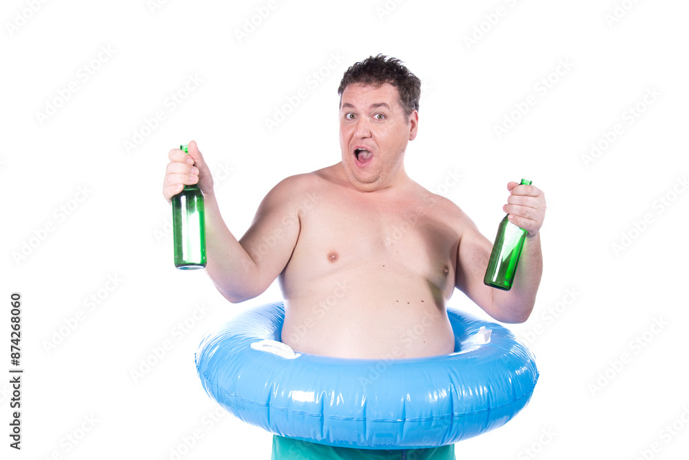 Funny fat man on vacation drinks beer. A guy with an inflatable ring posing on a white background. Funny fat man on vacation drinks beer. A guy with an inflatable ring posing on a white background.