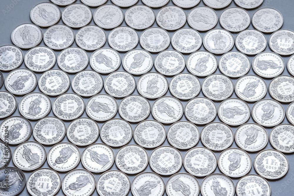 coins linearly spread on white background
