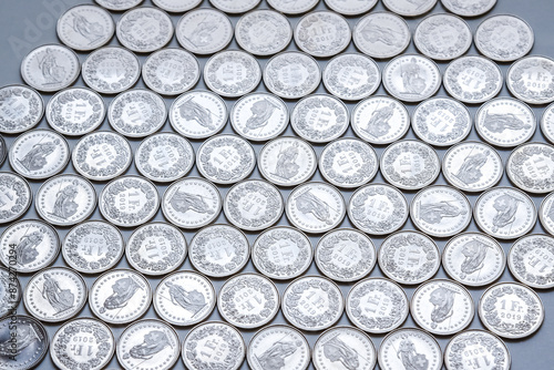 coins linearly spread on white background photo