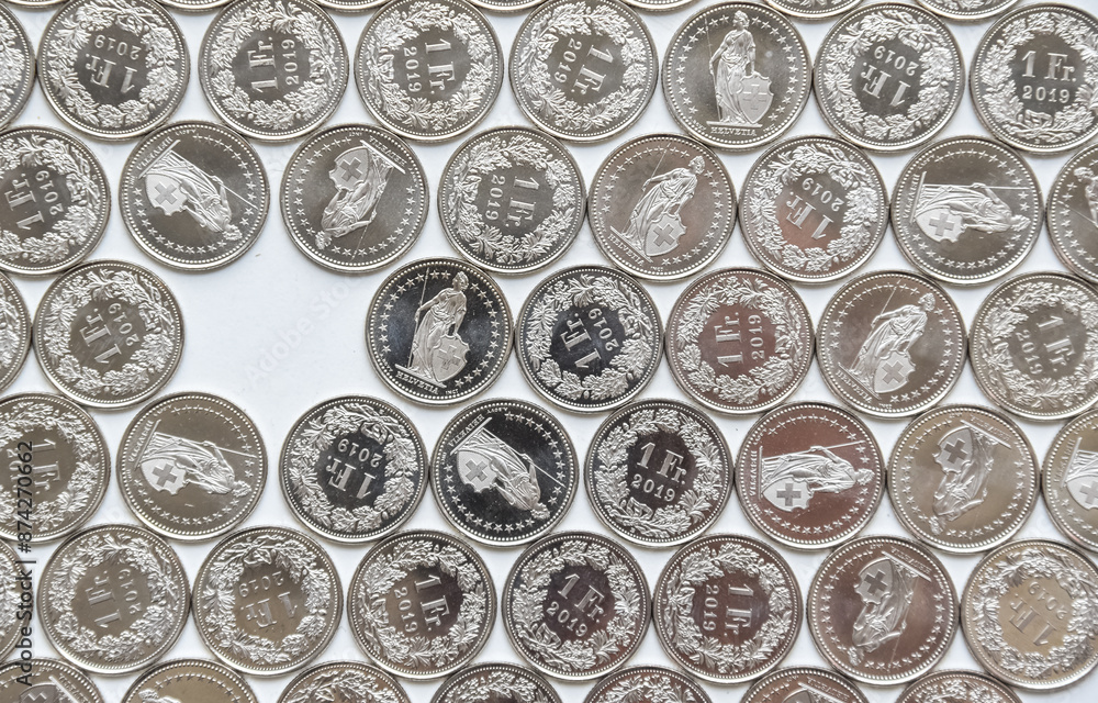 coins linearly spread on white background with a gap