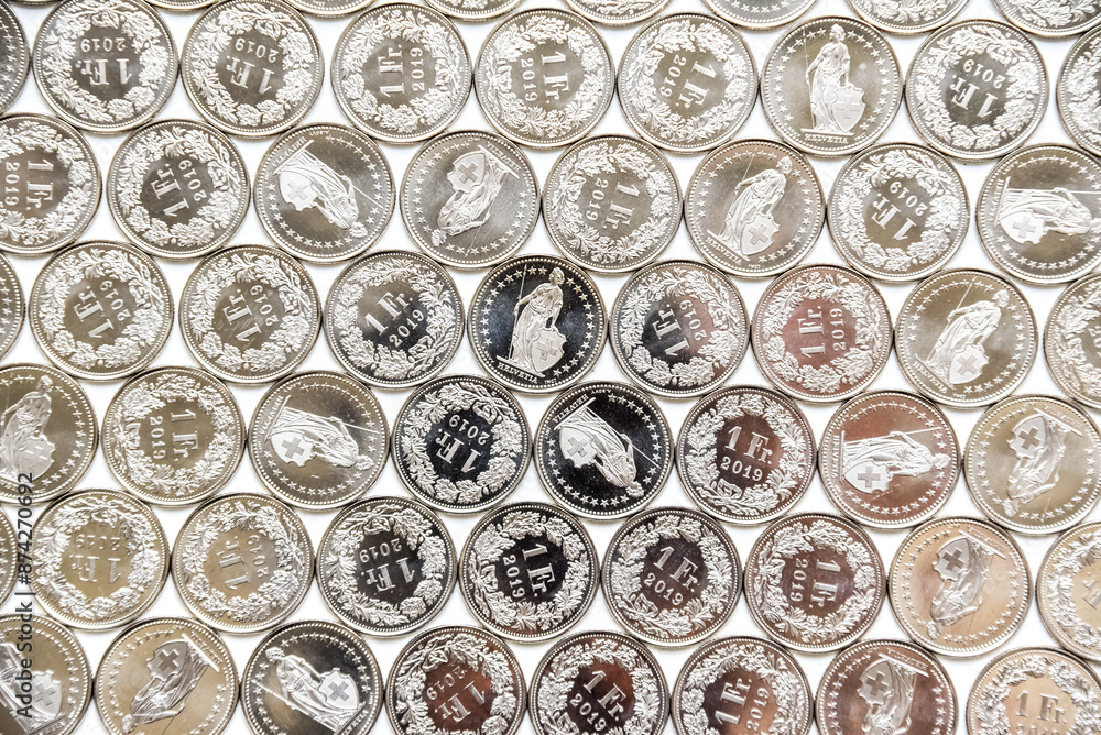 coins linearly spread on white background