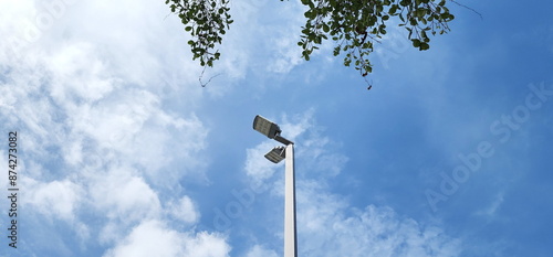 A modern street LED lighting pole. LED Street Light on blue sky, cloud background. electro-energy technologies. Outdoor LED Lighting. Solar panel street light - Eco-friendly
 photo