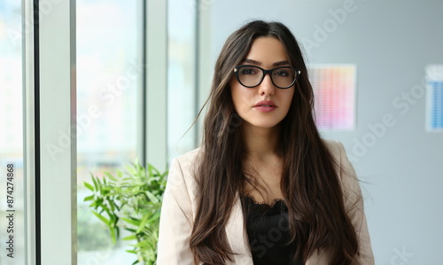 Portrait of beautiful woman at workplace, trendy suit, posing for camera, dress code for company workers. Female manager, promotion, career growth concept