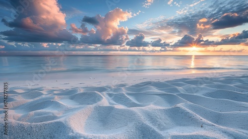 Fototapeta Naklejka Na Ścianę i Meble -  A quiet beach with fine, white sand, the sunrise creating a soft, pink glow across the horizon.