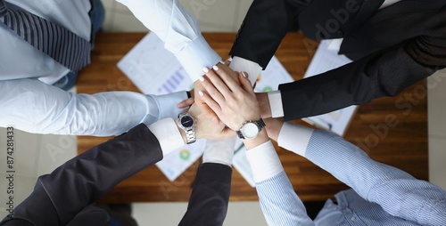 Fotografi Top view of colleagues performing gesture in order to prepare for important profitable project, change future of corporation