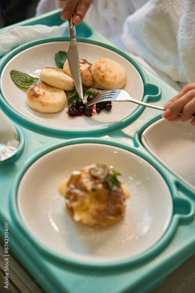 Close up of woman patient eating in bed in clinic
