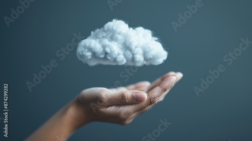 A hand holding a white cloud against a blue background, symbolizing cloud computing and data storage.