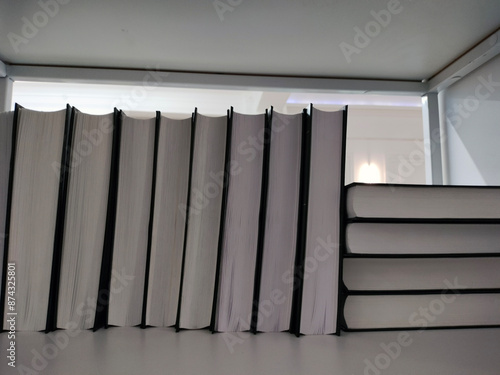 Books on a wooden shelf.