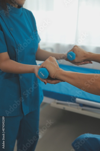 Wallpaper Mural Physiotherapist man giving exercise with dumbbell treatment About Arm and Shoulder of athlete male patient Physical therapy concept Torontodigital.ca