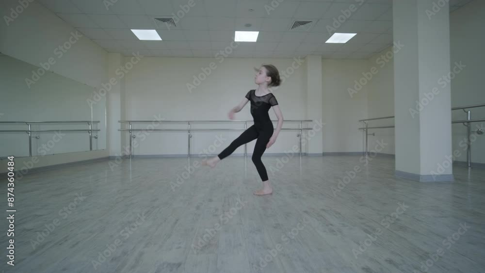 Young Ballerina Practicing Dance Moves in Studio Young Ballerina Practicing Dance Moves in Studio