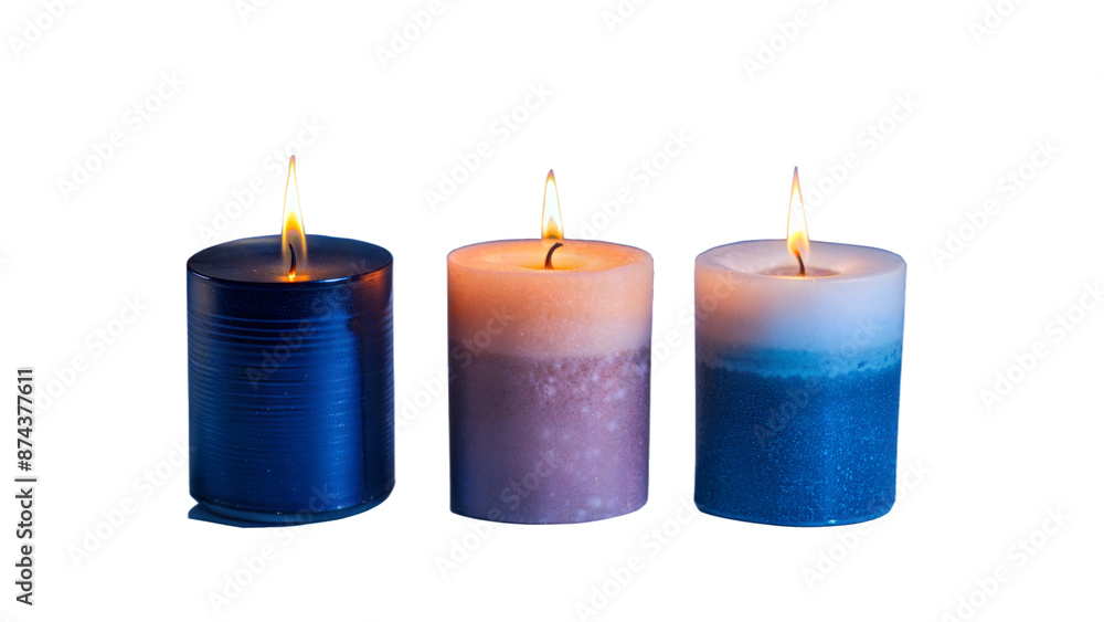 Three candles are lit, with one blue, one pink, and one purple Three candles are lit, with one blue, one pink, and one purple